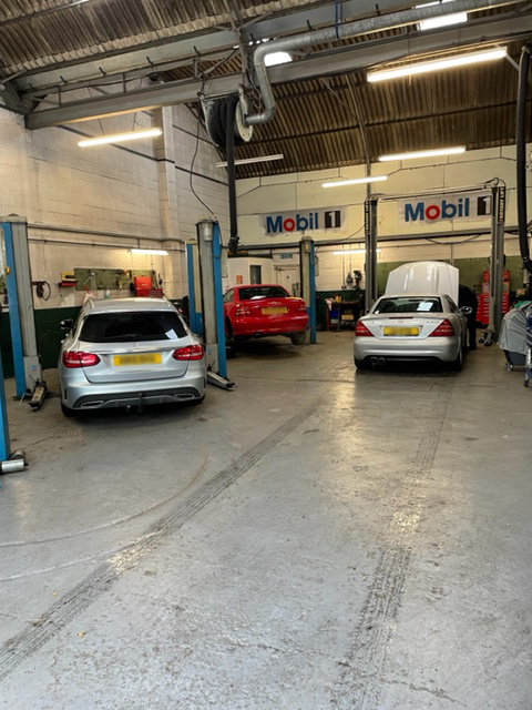 Garage with mercedes cars undergoing maintenance and repairs