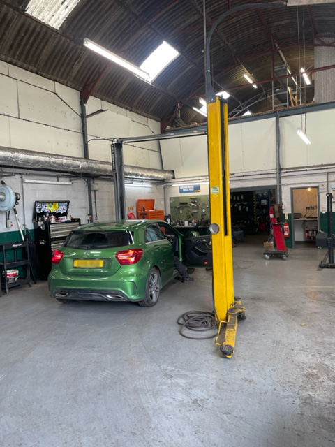 Garage with mercedes cars undergoing an MOT Test